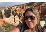 Julie Mizrahi posing in front of mountains on a hike at Bryce Canyon National Park